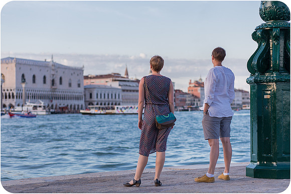 Lesbian couple enjoying a romantic summer afternoon in Venice, embracing love in a stunning setting.