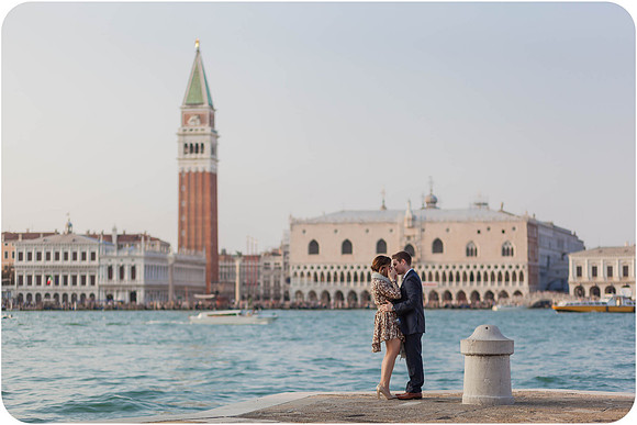 Man proposing to his partner near the waterfront with Venice’s landmarks behind them.