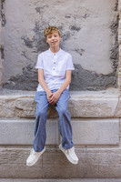 Solo portrait of young man by Venetian wall