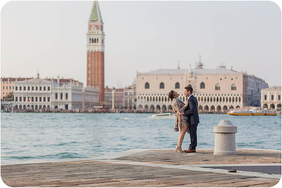 Couple embracing by the waterfront after a proposal in Venice.