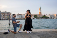 Man proposing at golden hour along Venice’s Punta della Dogana promenade.