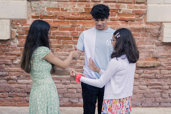 Siblings by a Venice bridge