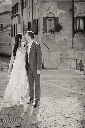 Couple walking on a quiet street in Venice after their proposal.