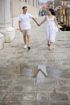 Couple walking hand in hand through the streets of Venice