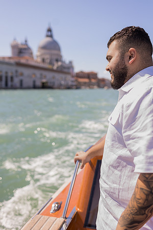 Father gazing out Venice water taxi