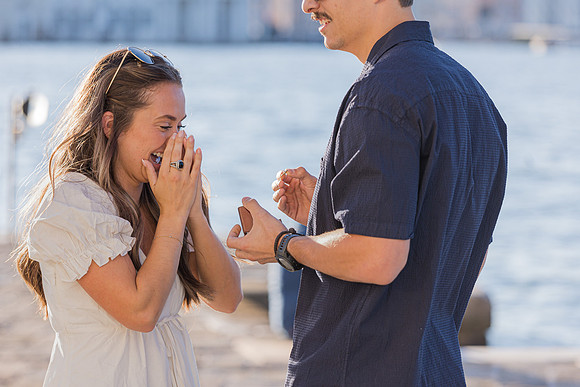 A newly engaged couple walks hand-in-hand through the charming streets of Venice.