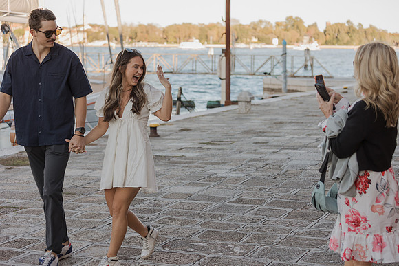 A couple celebrates their engagement aboard a romantic Venetian gondola.