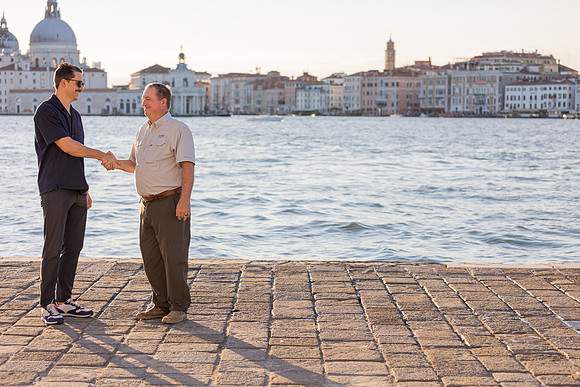 The perfect proposal moment captured under the warm hues of a Venetian evening.