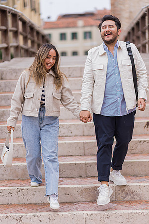 The couple walks hand in hand through Venice’s charming streets.