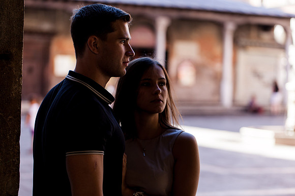 Couple posing in a shaded alleyway in Venice
