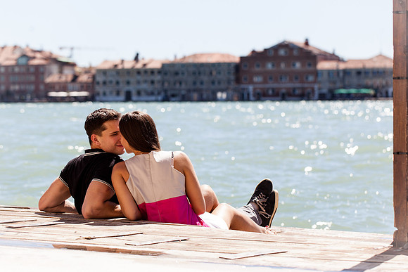 Couple sitting by the Grand Canal during golden hour
