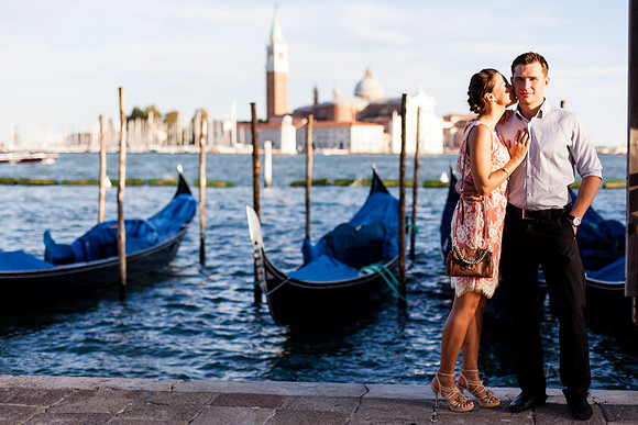 Couple standing by the waterfront in Venice at sunset