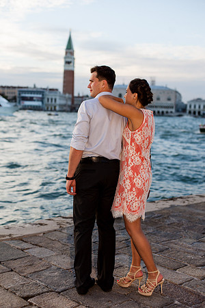Couple kissing by the water in Venice after a surprise proposal