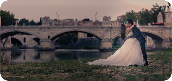 Bride and groom walking hand in hand on the streets of Rome after their wedding.
