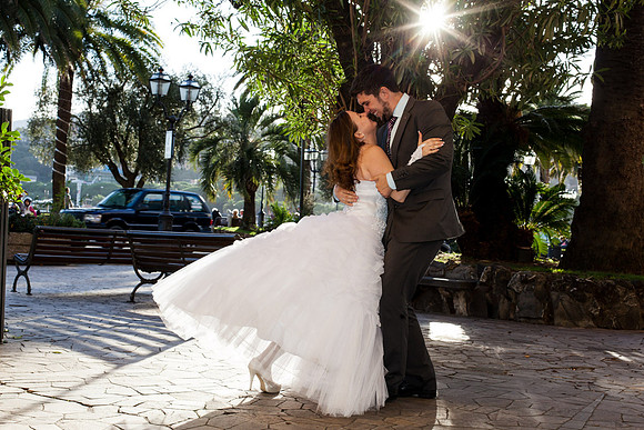 Bride and groom dancing under the trees at their wedding.