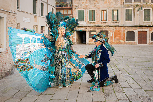 Couple sitting by the canal in their beautiful self-made costumes