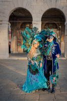 Couple in carnival attire standing between classical columns in the Riallo fish market