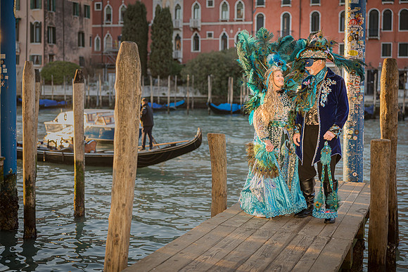 Full body shot of a couple in stunning self-made Venetian carnival attire
