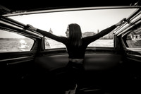 Woman relaxing on a water taxi during sunset in Venice