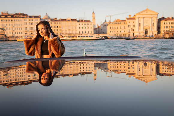 Reflection on a water taxi highlighting the Venice skyline