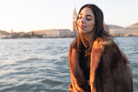 Portrait of a smiling woman with Venice skyline