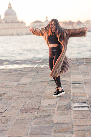 Portrait with fur coat by Venice waterside