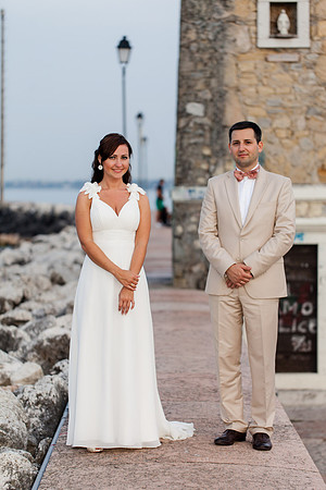 Bride and groom standing by the lighthouse.