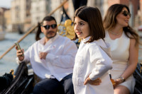 Family enjoying a peaceful gondola ride on the Grand Canal during their 10th anniversary in Venice