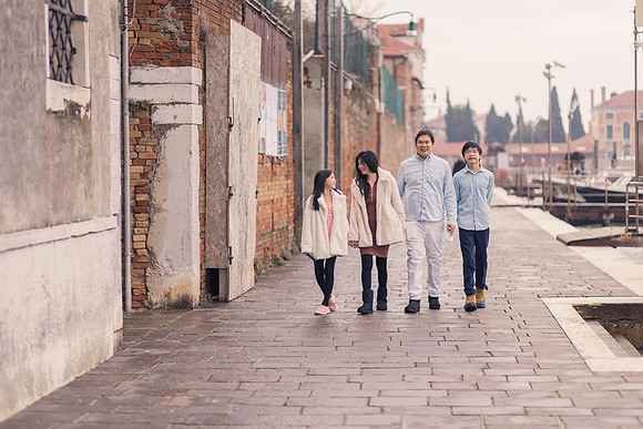 Family walking along a quiet Venetian street in winter.