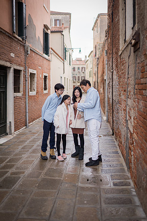 Family exploring a hidden corner of Venice during winter.