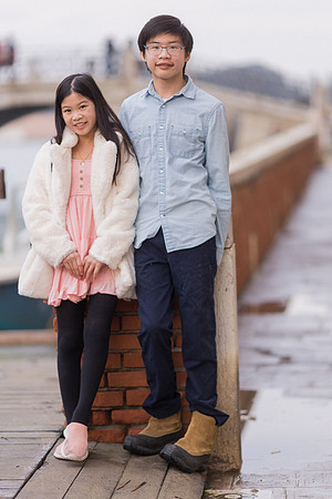 Father and daughter posing by the water in Venice during winter.