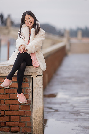Sister posing by the Venice waterfront in winter.
