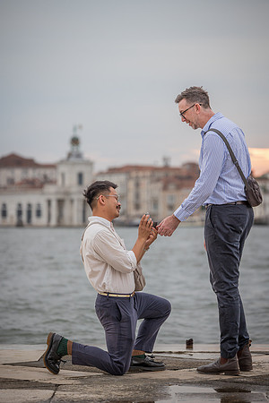 Man asking his partner to marry him at sunset in Venice.