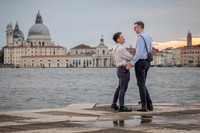Man down on one knee proposing to his partner on San Giorgio Island.