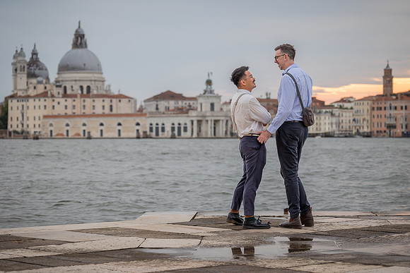 Man down on one knee proposing to his partner on San Giorgio Island.