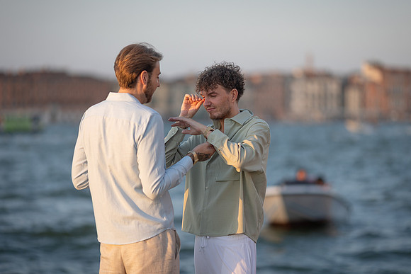 Silhouette of a couple during a sunset proposal in Venice