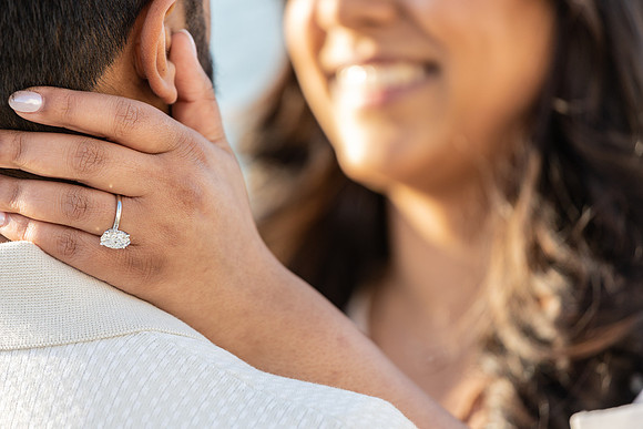 A timeless moment as a couple celebrates their engagement at sunset.