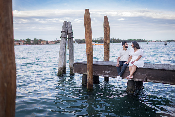 A heartfelt kiss after a surprise proposal on the Venice waterfront.