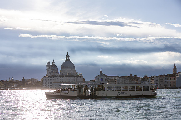 A romantic sunset proposal in Venice, capturing a couple's joyful embrace.