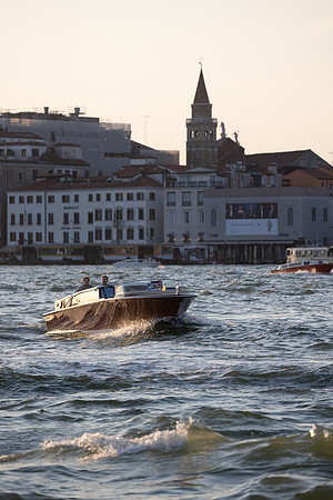 A traditional water taxi arriving at San Giorgio Island in Venice