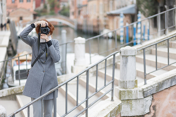 Photographer walking through the streets of Venice