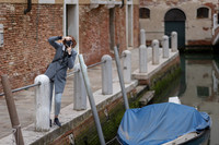 Photographer walking along Venice canals