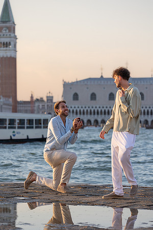 A romantic gay proposal at sunset on San Giorgio Island in Venice