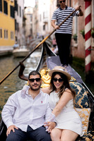 Parents enjoying their 10th anniversary gondola ride through Venice’s canals