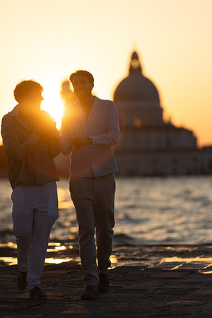 A silhouette of a couple embracing at twilight in Venice