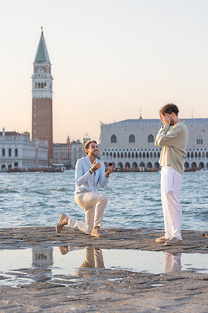 A couple embracing during a sunset proposal in Venice