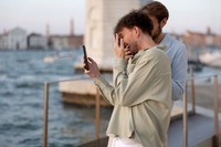 A couple looking at a phone during their proposal