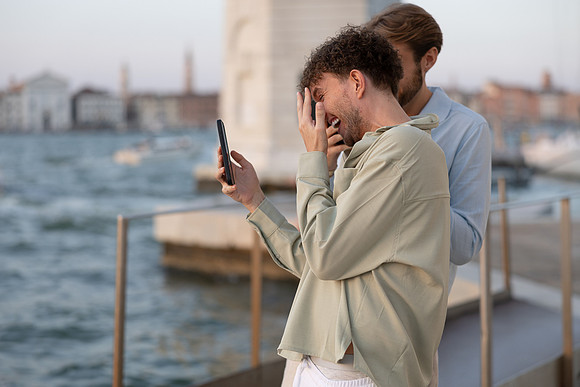 A couple looking at a phone during their proposal