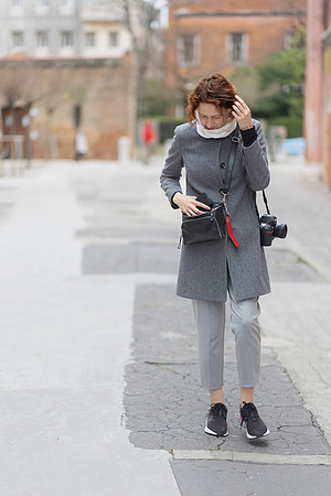 Photographer holding camera, smiling in Venice