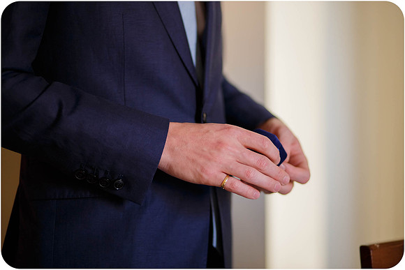 Groom's hands holding a wedding ring before the ceremony in Venice.